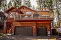 Luxiouous log cabin with decks and bear decor in South Lake Tahoe with tall trees behind Royalty Free Stock Photo