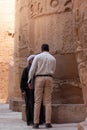LUXOR, EGYPT - 27 Dec 2022. Security guard talking to a local egiptian man between ancient ruins of Karnak temple