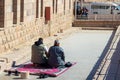 LUXOR, EGYPT - 27 Dec 2022. Unrecognizable muslim,arab, egyptian dad and son praying kneeling in religious moment on a