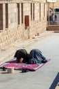 LUXOR, EGYPT - 27 Dec 2022. Vertical view of two adult muslim arab men in praying position during ramadan time