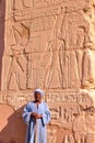 LUXOR, EGYPT - NOVEMBER 2, 2011: Portrait of a guard in front of hieroglyphs in Karnak temple Royalty Free Stock Photo