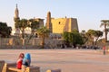 LUXOR, EGYPT - NOVEMBER 4, 2011: Two young Egyptian girls sitting in front of Luxor temple