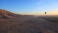 Luxor Egypt panorama view riding hot air balloon over valley of the king sunrise aerial view video