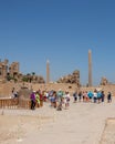 Travel tour group wanders through Karnak Temple. Egyptian landmark with hieroglyphics, decayed Royalty Free Stock Photo