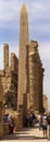 Karnak Temple, complex of Amun-Re. Embossed hieroglyphics on columns and walls. Tourists visiting the sights. Royalty Free Stock Photo