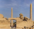 Karnak Temple, complex of Amun-Re. Embossed hieroglyphics on columns and walls. Tourists visiting the sights. Royalty Free Stock Photo