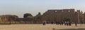 Karnak Temple, complex of Amun-Re. Embossed hieroglyphics on columns and walls. Tourists visiting the sights Royalty Free Stock Photo