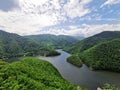 luxuriant landscape of a lake surrounded by dense forest incredible aerial view in Romania Transylvania