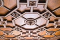 Luxurious antique wooden ceiling decorations in an old minor. Expensive geometric shapes made of hard wood