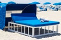 Luxurious beach bed with canopy on a sandy beach