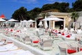 Luxurious beach, white umbrellas by pool. White trendy sun loungers and chairs, beach furniture by sea, Beautiful summer Sibenik,