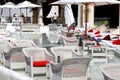 Luxurious beach, white umbrellas by pool. White trendy sun loungers and chairs, beach furniture by sea, Beautiful summer Sibenik, Royalty Free Stock Photo