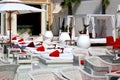 Luxurious beach, white umbrellas by pool. White trendy sun loungers and chairs, beach furniture by sea, Beautiful summer view.