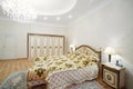 Luxurious bedroom with gilt double bed and bedside tables Royalty Free Stock Photo