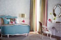 Luxurious bedroom interior with colored bed and dressing table Royalty Free Stock Photo