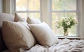 Luxurious bedroom interior with soft pillows and sunlight streaming in Royalty Free Stock Photo