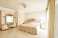 Luxurious bedroom in pastel colours in a neoclassical style, wit Royalty Free Stock Photo