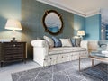 Luxurious beige sofa in a classic style with two wooden bedside tables with lamps and a mirror on a light blue wall background