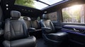 Luxurious black leather interior of modern minivan with sunroof in urban setting Royalty Free Stock Photo