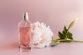 A luxurious bottle of women`s perfume with notes of peony. delicate floral fragrance. the expression of natural odors. pink Royalty Free Stock Photo