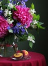 Luxurious bouquet of peonies, irises and jasmine and peaches