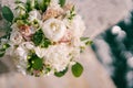 Luxurious bridal bouquet of peonies, roses and green branches. Top view