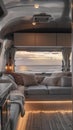 Luxurious camper interior framing a breathtaking seaside sunset view, featuring comfortable lounging spaces and modern Royalty Free Stock Photo