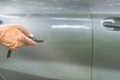 A luxurious car owner stretching hand to use a key remote control to lock and unlock his car, a photo of selective focus with Royalty Free Stock Photo