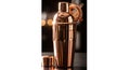 Luxurious copper cocktail shaker and strainer set Royalty Free Stock Photo