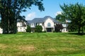 luxurious country house with a large green lawn in the front yard Royalty Free Stock Photo