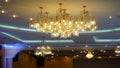 Luxurious crystal chandelier on the ceiling. Bottom view. Close-up. Huge crystal gold chandelier with candles.