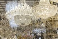 Luxurious crystal chandeliers in the store. Decor and interior design. Close-up. Blurred