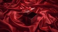 Luxurious Dark Red Gift Box on Elegant Draped Red Satin Fabric Background Royalty Free Stock Photo