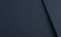 Luxurious designer paper background in deep navy blue with a smooth, shadowed texture. This dark,