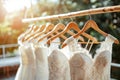 Luxurious display of elegant white bridal gowns on hangers in upscale boutique for weddings