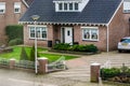 Luxurious dutch bungalow from street view, with beautiful garden and a gate, modern dutch architecture, home in a small village of Royalty Free Stock Photo