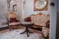 Luxurious and elegant room with ornate furniture and mirror, timeless interior design concept. Royalty Free Stock Photo