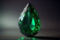 A luxurious emerald with green iridescence against a black background gleams majestically.