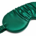 Luxurious emerald green silk eye mask for comfortable sleep Royalty Free Stock Photo