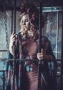 Luxurious fashion stylish girl in cage. Flower dress and a wr Royalty Free Stock Photo