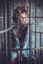 Luxurious fashion stylish girl in cage. Flower dress and a wr Royalty Free Stock Photo