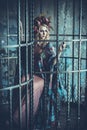 Luxurious fashion stylish girl in cage. Flower dress and a wr Royalty Free Stock Photo