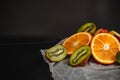 Luxurious fruit background.Orange and kiwi in a cut. Studio photography of various fruits isolated on black background