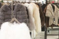 Luxurious fur coats for women in different colors hanging on sal