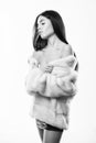 Luxurious fur. Female with makeup wear mink beige fur coat. Girl posing fur coat. Woman attractive nude shoulders wear