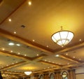 Luxurious gold color ceiling with some artistic lamps