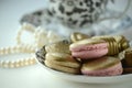 Luxurious gold French macarons and chocolates on a porcelain plate Royalty Free Stock Photo