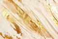 Luxurious golden brushstrokes sweep across a creamy beige canvas, creating a textured, opulent abstract artwork that
