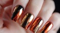 Luxurious Golden and Chrome Manicure Close-up. Close-up view of a hand with shiny metallic gold and chrome nail polish Royalty Free Stock Photo