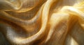 Luxurious golden textile background with delicate threads in a draped and folded arrangement highlighting texture a Royalty Free Stock Photo